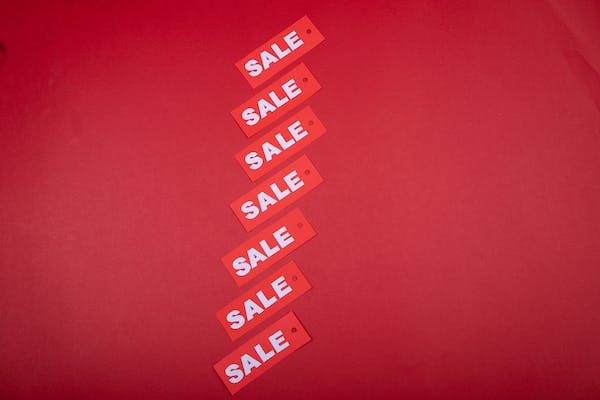Sale signs with red background and white letters.